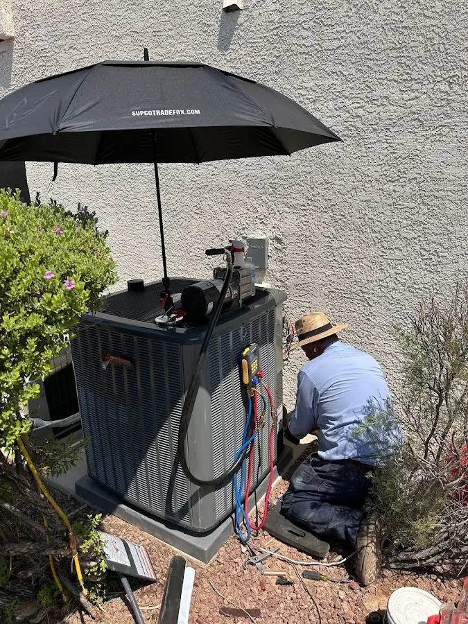 HVAC technician performing outdoor AC maintenance in Whitehall